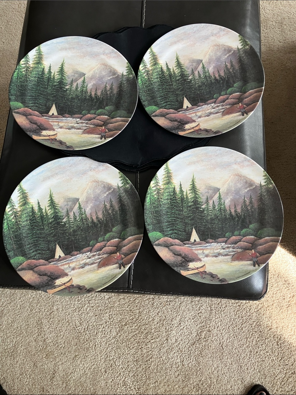 Four plates and placemats by artist David Carter Brown